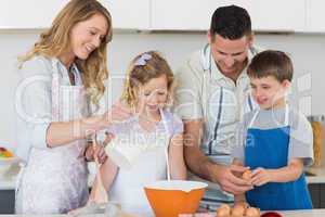 Family making cookies together in kitchen