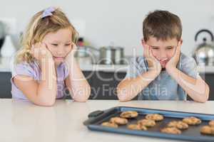 Brother and sister looking at tempting cookies