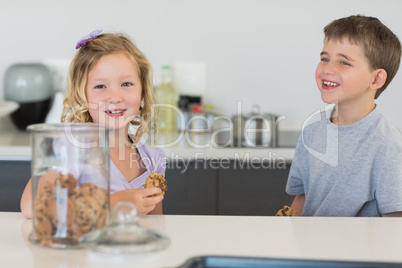 Brother and sister having cookies