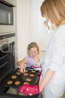 Mother and daughter baking cookies