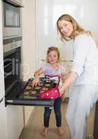 Woman baking cookies with daughter