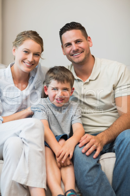 Family sitting together on sofa