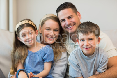 Parents and children sitting on sofa