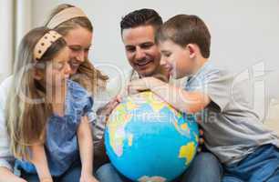 Family searching places on globe