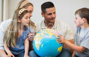 Family with globe in house