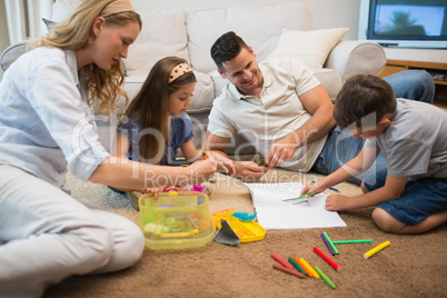 Family assisting boy in drawing