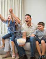 Family screaming while watching television