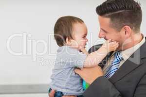 Businessman touching cheek of baby boy