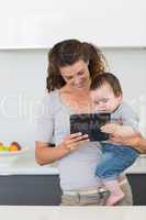Mother and baby using digital tablet