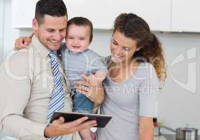 Happy baby with parents using digital tablet