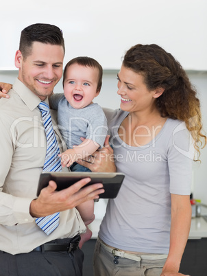 Businessman with digital tablet and family