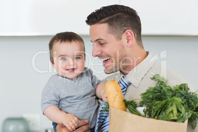 Happy baby being carried by businessman
