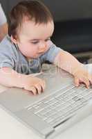 Baby using laptop at table