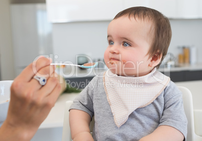 Innocent baby being fed by mother