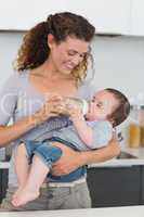 Woman feeding milk to baby
