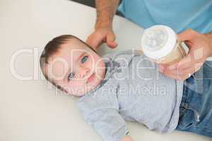 Innocent baby with father feeding milk