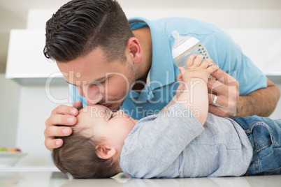 Loving father kissing baby on forehead