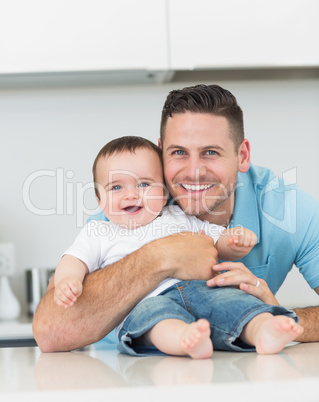 Happy father embracing baby