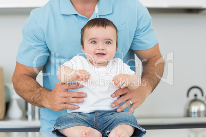 Adorable baby sitting on counter