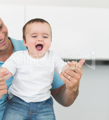 Cheerful baby with father at home