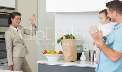 Businesswoman waving to family