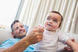 Happy father with baby at home
