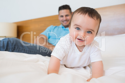 Adorable baby boy on bed