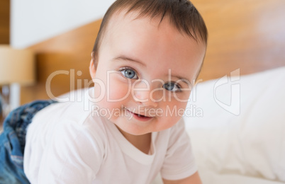 Smiling baby boy in bed