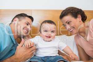 Cheerful baby with parents