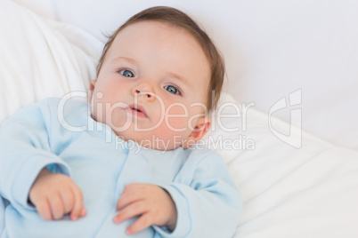 Portrait of adorable baby in bed