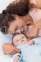 Happy mother tickling baby