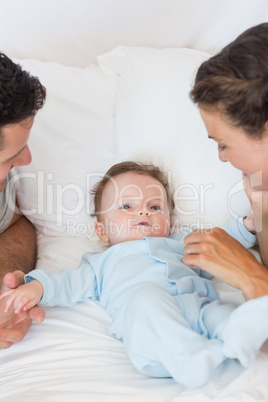 Caring parents playing with baby