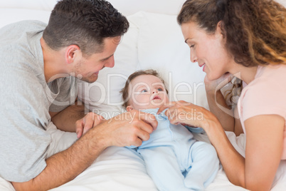 Happy parents playing with baby boy