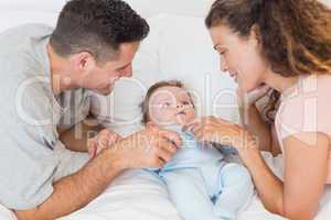 Happy parents playing with baby boy