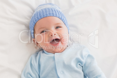 Portrait of cheerful baby in bed