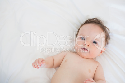 Portrait of lovely baby lying in bed