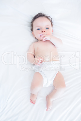 Innocent baby with finger in mouth