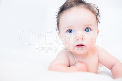 Lovely baby with blue eyes in bed