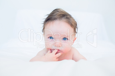 Cute baby with finger in mouth