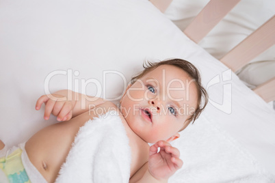 Adorable baby lying in crib