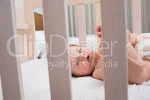 Innocent baby boy lying in crib