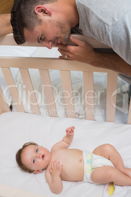 Loving father looking at cute baby