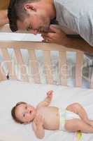Loving father looking at cute baby