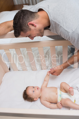 Cute baby looking at father