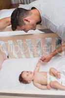 Cute baby looking at father