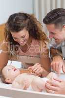 Happy parents playing with baby