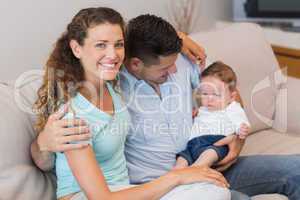 Happy woman with man holding baby