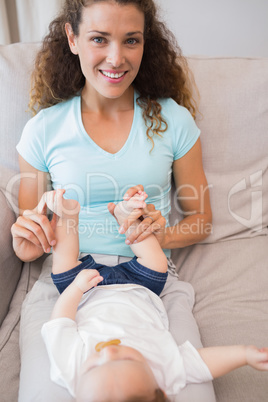 Happy mother with baby in living room