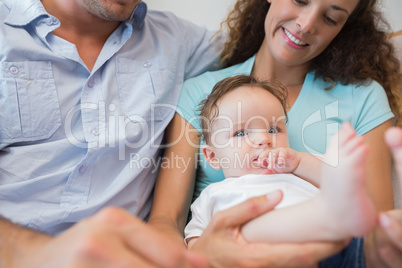 Cute baby sitting with parents