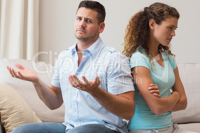 Man gesturing while arguing with woman